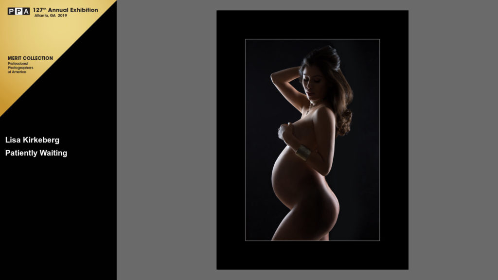 color image of nude pregnant woman with long hair covering her breast