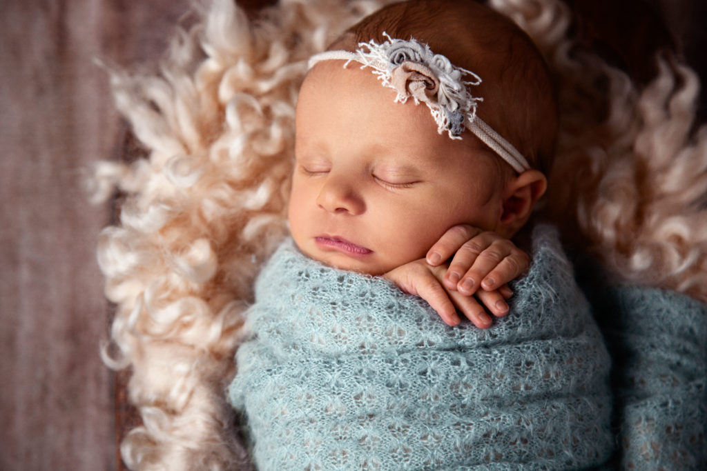 newborn baby girl wrapped in blue blanket, sleeping newborn, swaddled baby, sleeping baby posed