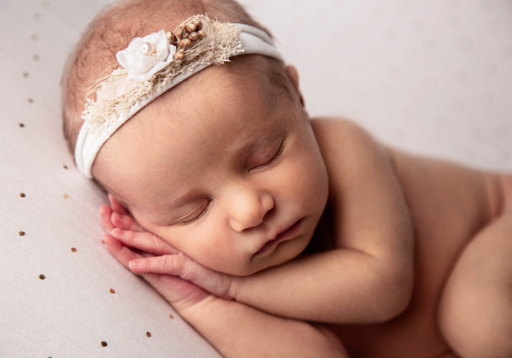 sleeping baby girl newborn on polka dot blanket, baby girl white headband, newborn baby pose