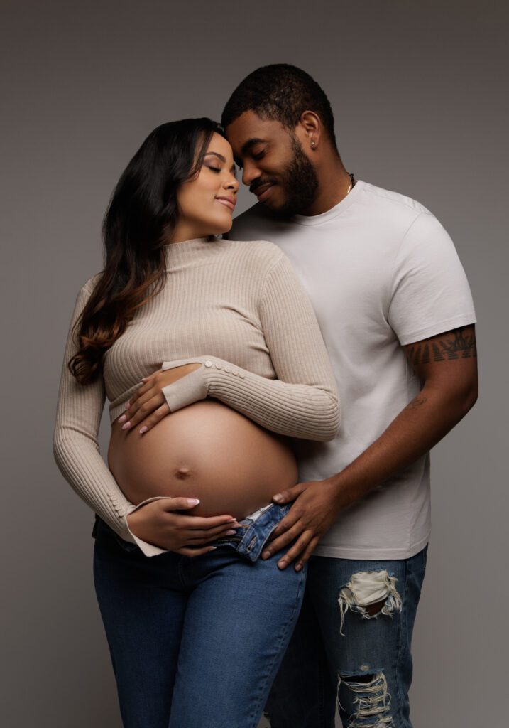 maternity photoshoot of couple in casual clothes