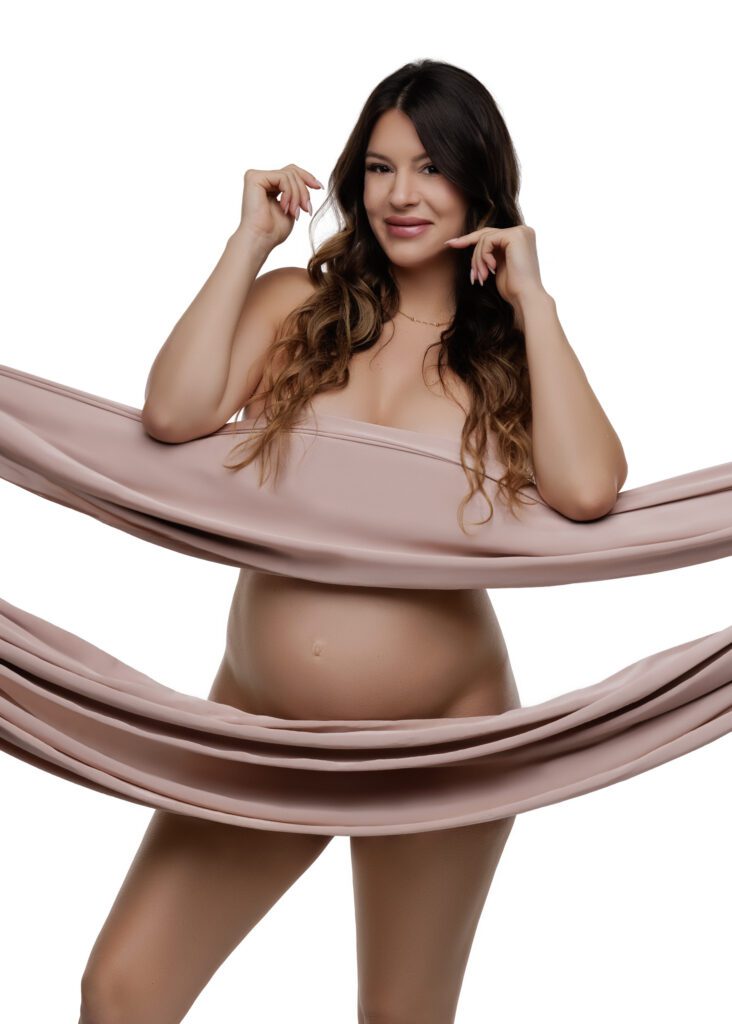 pregnant woman with pink fabric covering