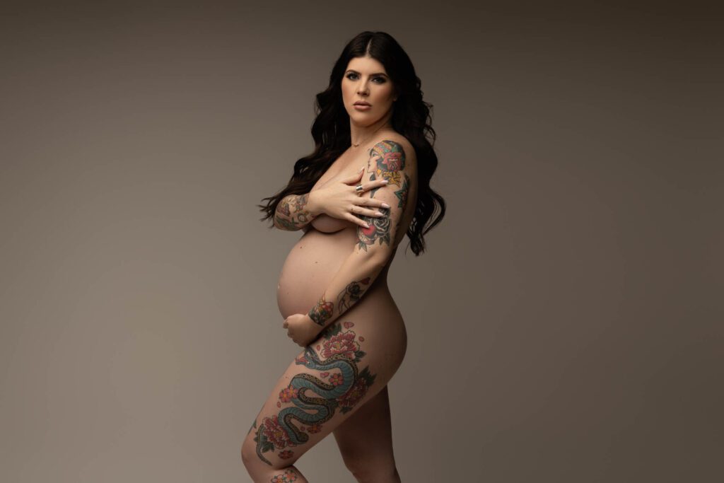 pregnant woman with tattoos posing