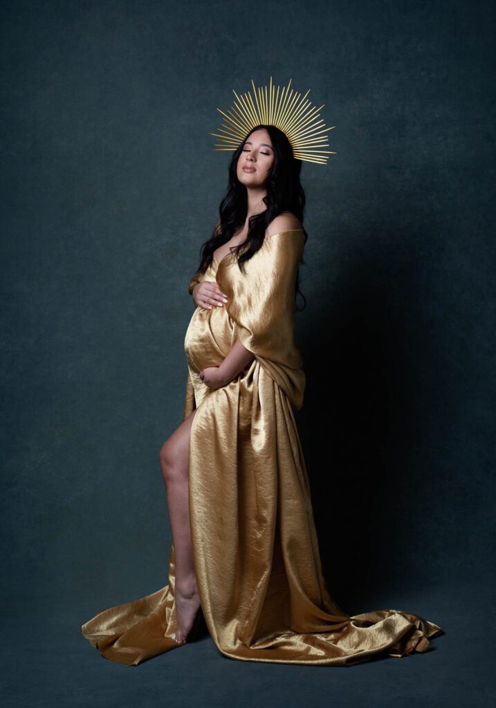 pregnant woman in gold silk with gold headband