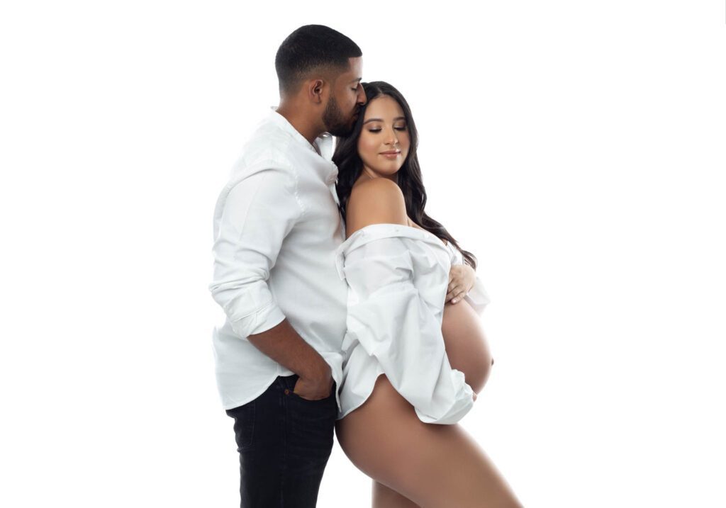 pregnant lady with partner posing in studio